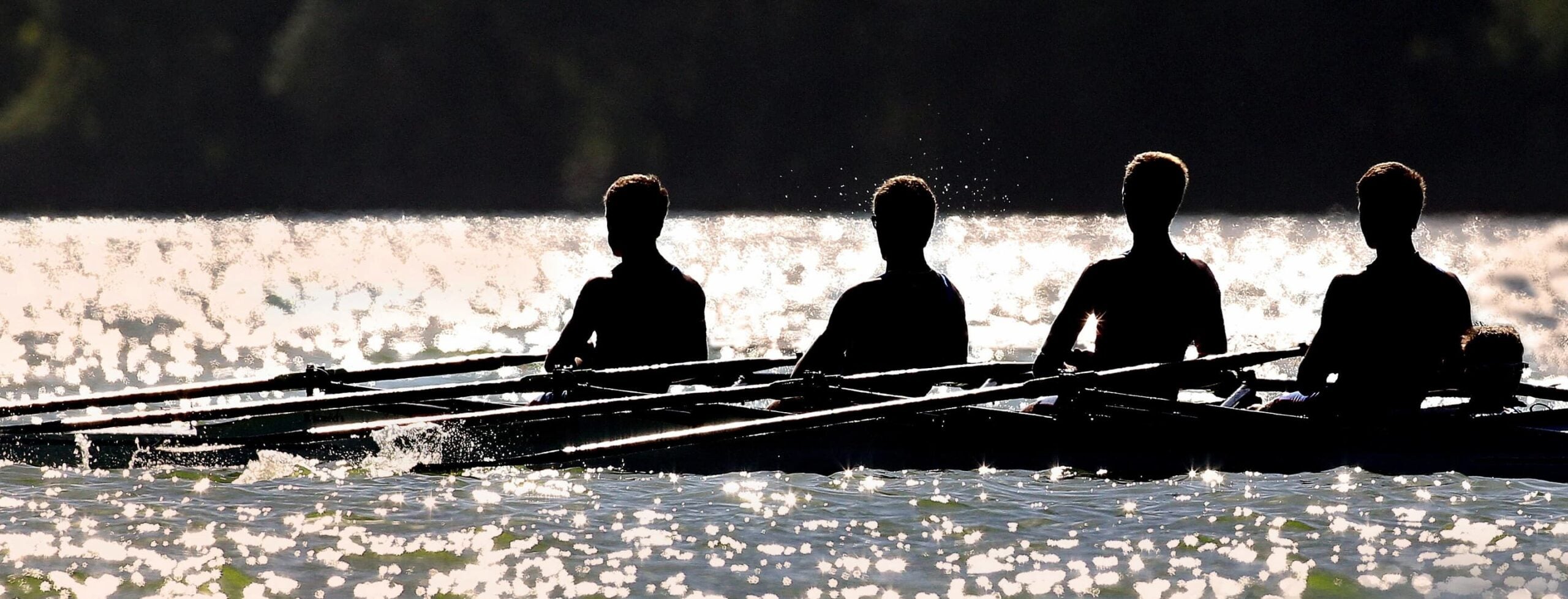 Men rowing in row boat race